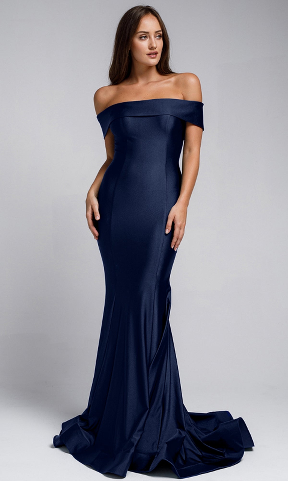 A woman models the Sleek Simple Off-the-Shoulder Long Prom Dress 373, a navy blue, floor-length gown, against a plain gray background.